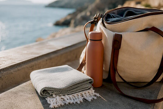 Folded peshtemal beside travel water bottle