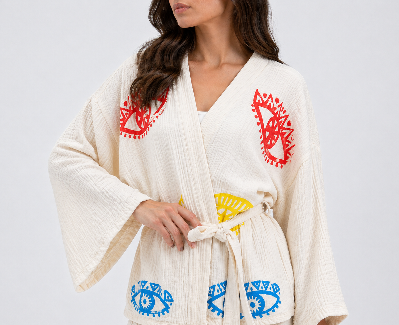 Front view of the Zaria Cream Natural Cotton Kimono Set featuring colorful hand block printed evil eye motifs and an adjustable waist tie. Kimono set robe