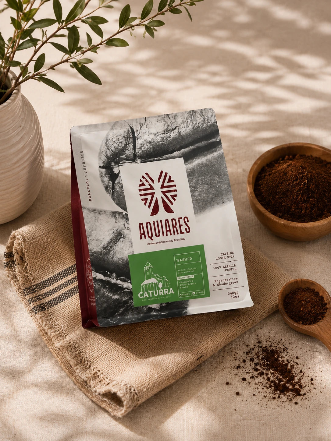 Aquiares Caturra Costa Rican ground coffee displayed with bowls of freshly ground coffee on natural linen in warm sunlight.