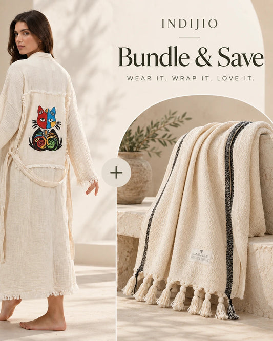 A woman a colorful embroidered cat on the back. An inset shows a matching cream throw blanket with black stripes and tassels.