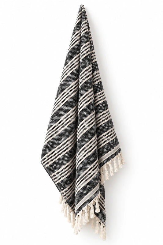 Mevsim Turkish cotton peshtemal towel in black and natural ivory stripes with hand-tied tassels.