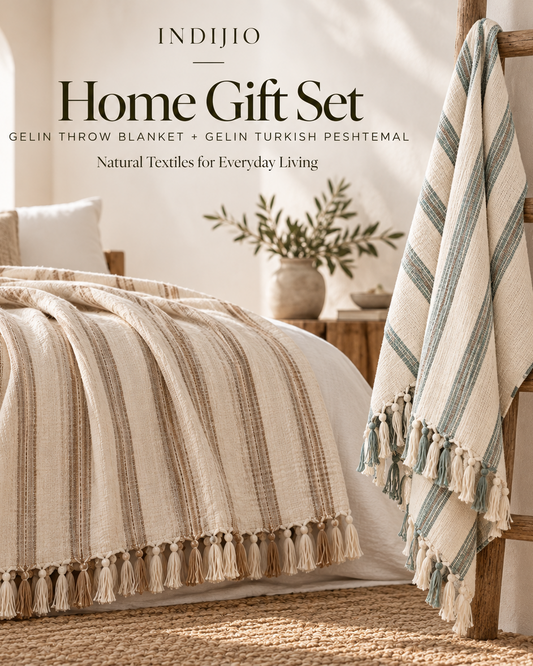 Indijio Home Gift Set with Gelin natural cotton throw blanket and striped Turkish peshtemal styled in a warm, minimalist bedroom.