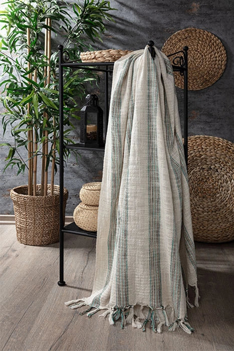 Gelin striped Turkish peshtemal towel draped in a natural interior, featuring a lightweight cotton weave and tasseled edges.