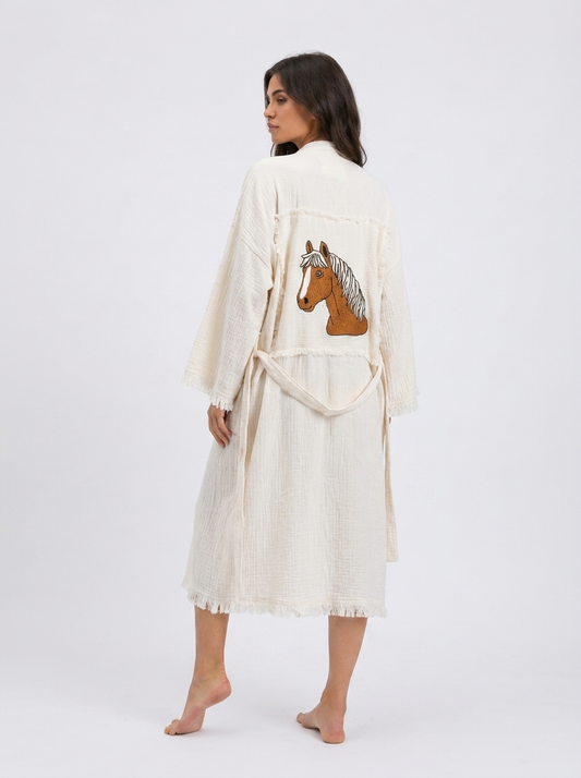 Full back view of the Happy Horse artisan-made cream cotton kimono robe with a large embroidered brown horse motif, patchwork-style back panel, relaxed long fit, matching belt, and fringe trim.