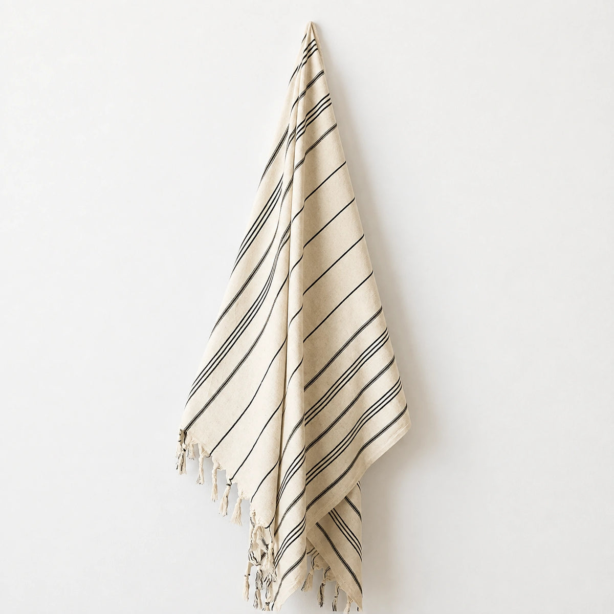 Lale cotton-linen Turkish towel in natural ivory with fine black woven stripes and hand-knotted tassel fringe.