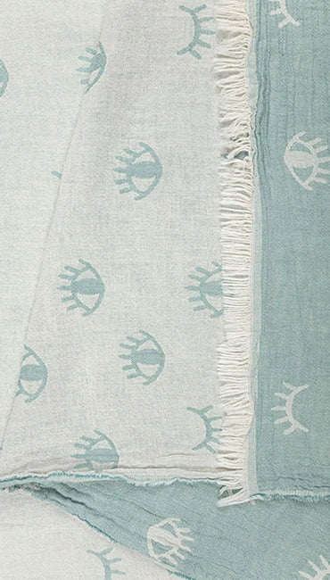 Lia mint 100% cotton Turkish peshtemal towel showing its soft aqua eye motif, contrasting reverse and fringed edge.