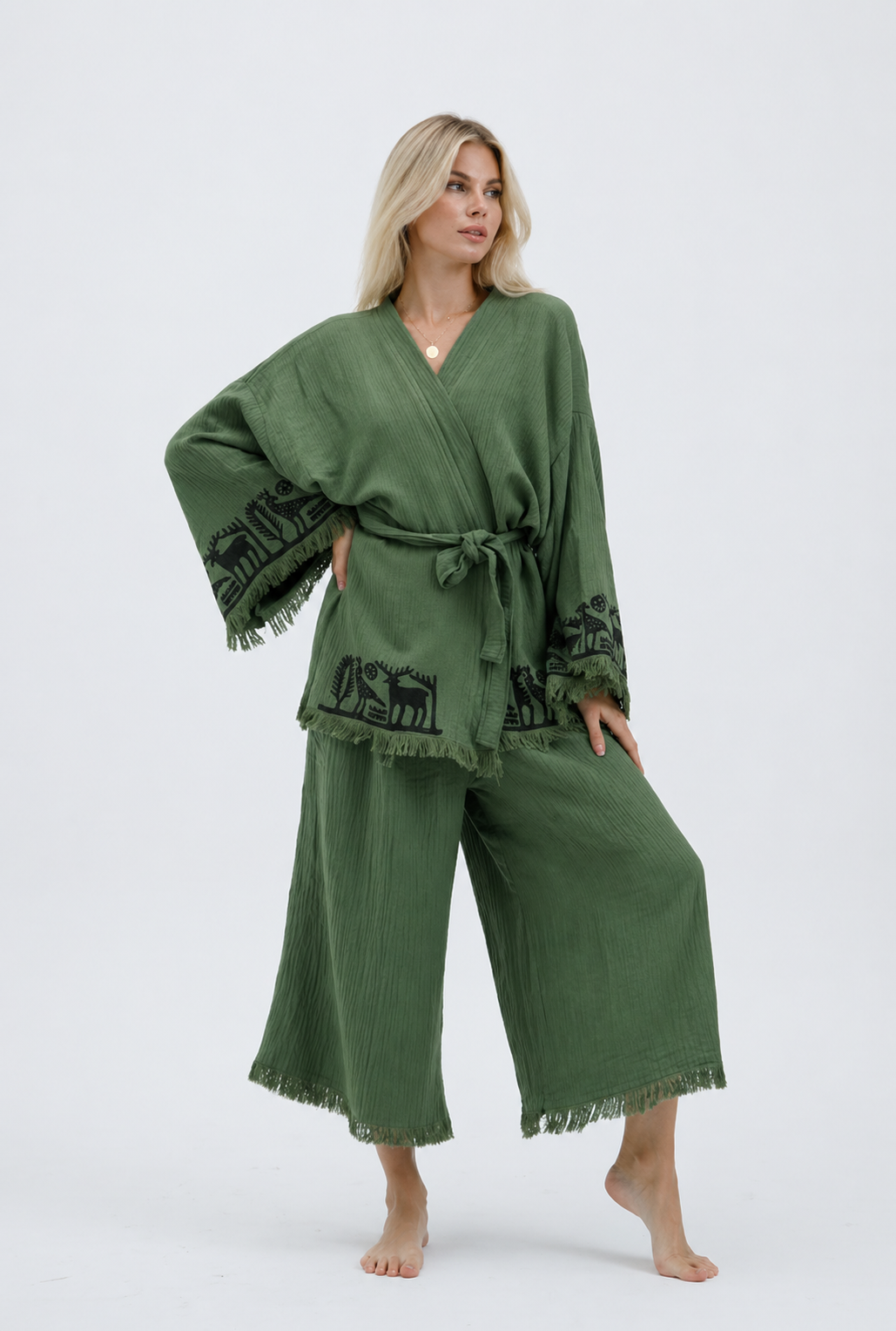 Front view of sage green textured cotton kimono jacket and wide-leg pants set with black Anatolian animal motifs and fringed sleeves.